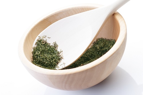 Dried thyme on wooden spoon